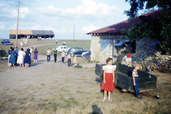 Dining Hall.  Melinda in Red Skirt. Tent is where basketball court is now. Photo by Orlando Dick, a Friends Pastor in Argonia and Liberal.